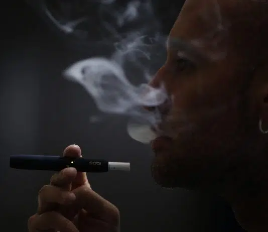 Un homme fumant une cigarette IQOS